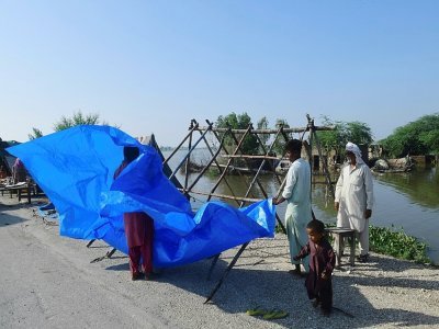 Des habitants touchés par les inondations dressent une tente à Shikarpur, dans la province du Sind, le 31 août 2022 au Pakistan - Asif HASSAN [AFP]
