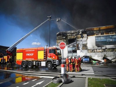 Les sapeurs-pompiers en train d'éteindre l'incendie d'un entrepôt du marché de Rungis, au sud de Paris, le 25 septembre 2022 - Christophe ARCHAMBAULT [AFP]