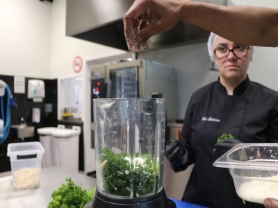 En cuisine, les élèves du Greta apprennent tout de A à Z, de l'épluchage des légumes aux cuissons en passant par les assaisonnements comme ici, où du persil a été mis dans un mixeur. Un élève saupoudre ici du parmesan. - Justine Carrère